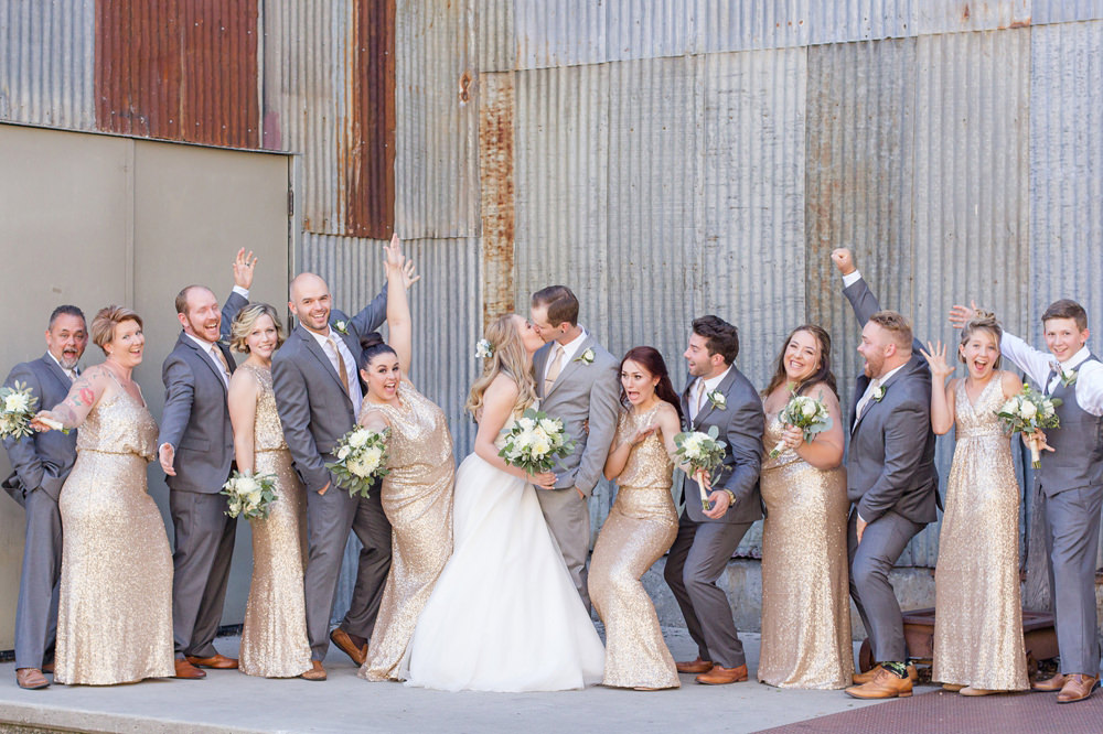 excited bridal party celebrating the newlyweds by Adrienne & Dani Photography
