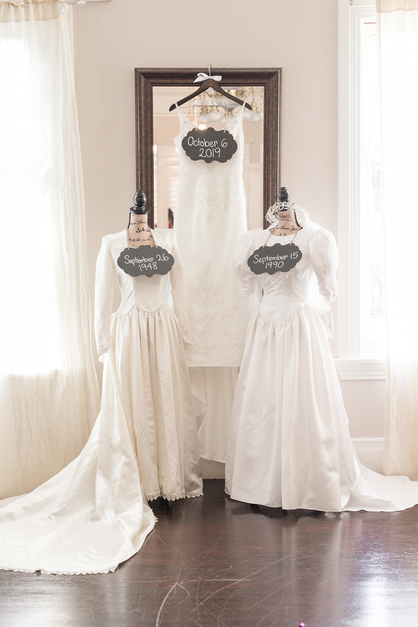 Brides Wedding Dress with Mom's and Grandmother's Wedding Dresses by Adrienne & Dani Photography