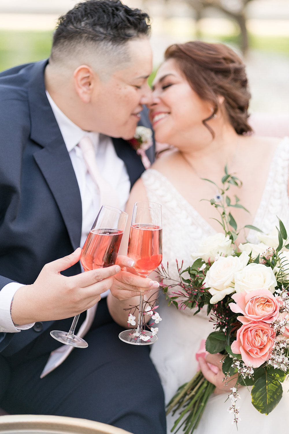 lgbtq couple clinking champagne glasses in woodland, ca