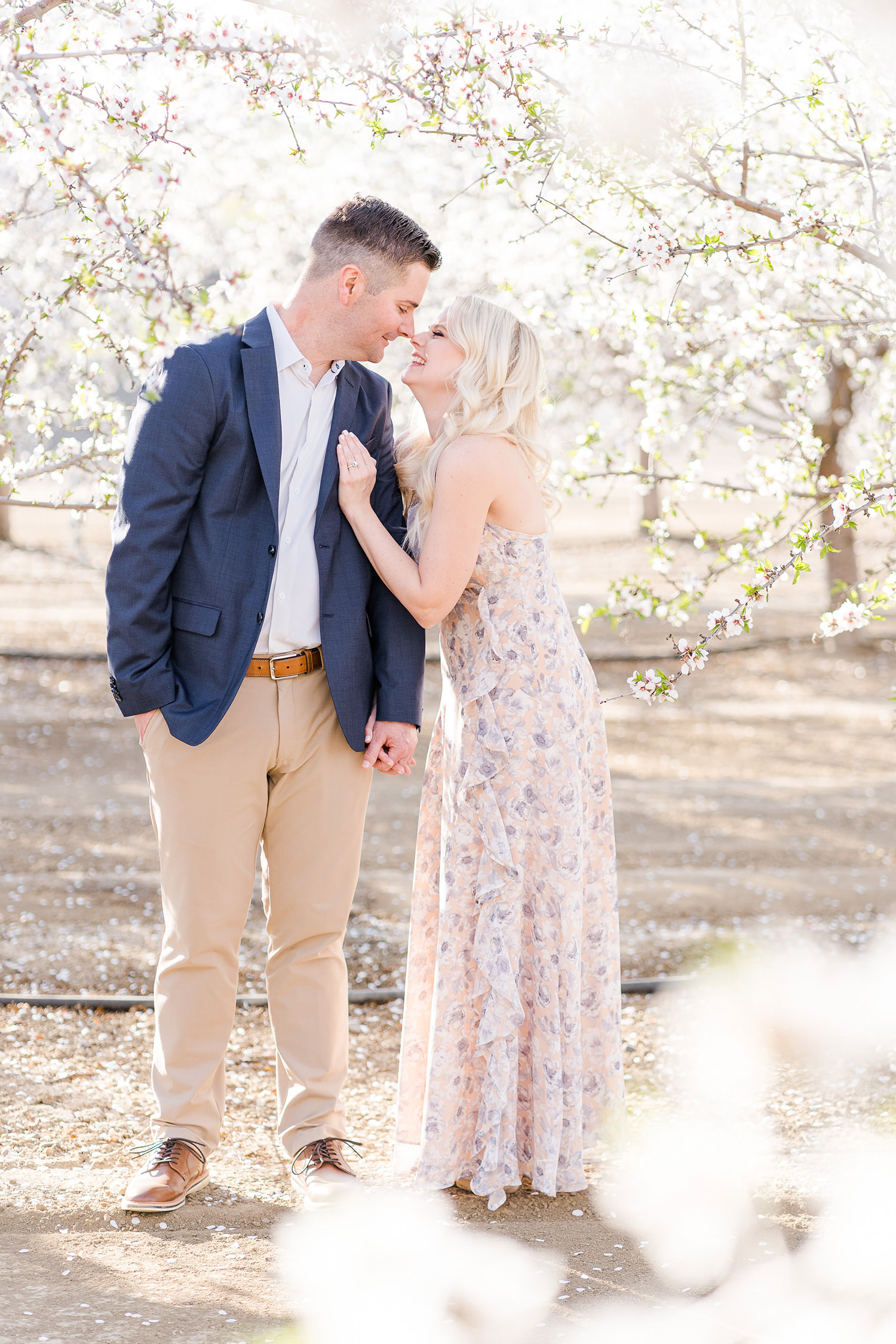Newly engaged couple pose for their woodland engagement session photos with Adrienne and Dani Photography
