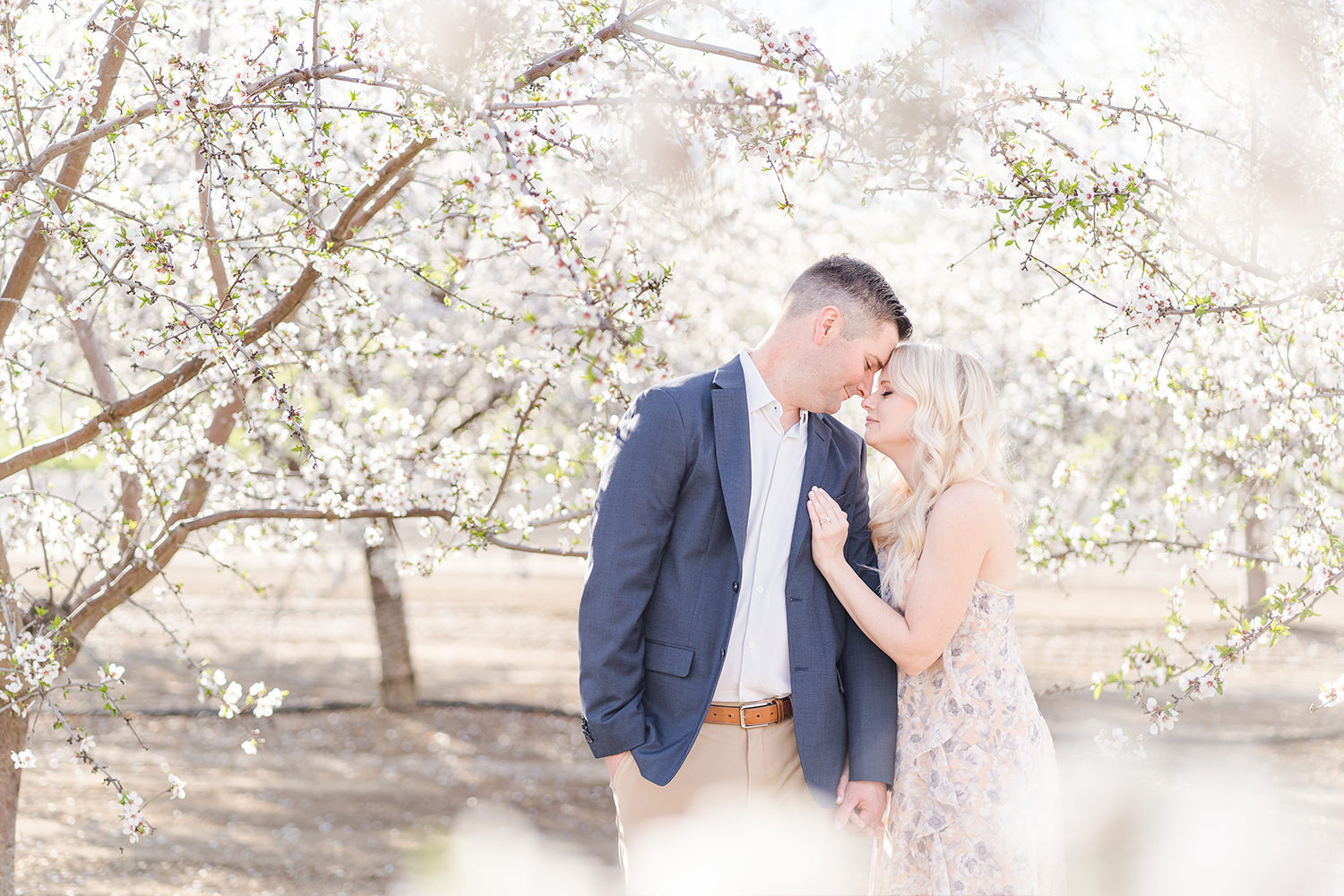 Newly engaged couple pose for their woodland engagement session photos with Adrienne and Dani Photography