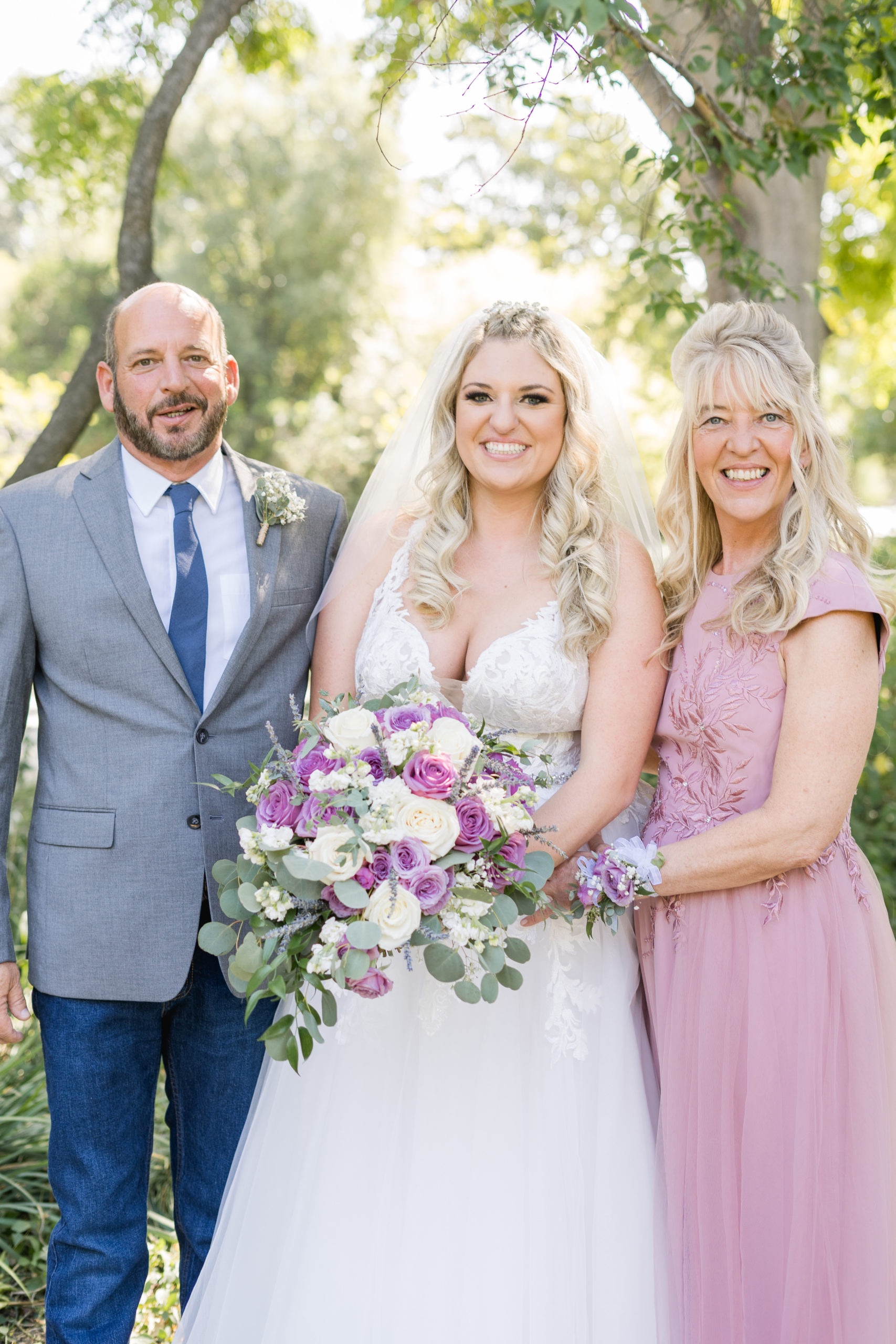 a bride poses with her parents for a  a wedding day family portrait by adrienne and dani photography, Napa Wedding Photographers