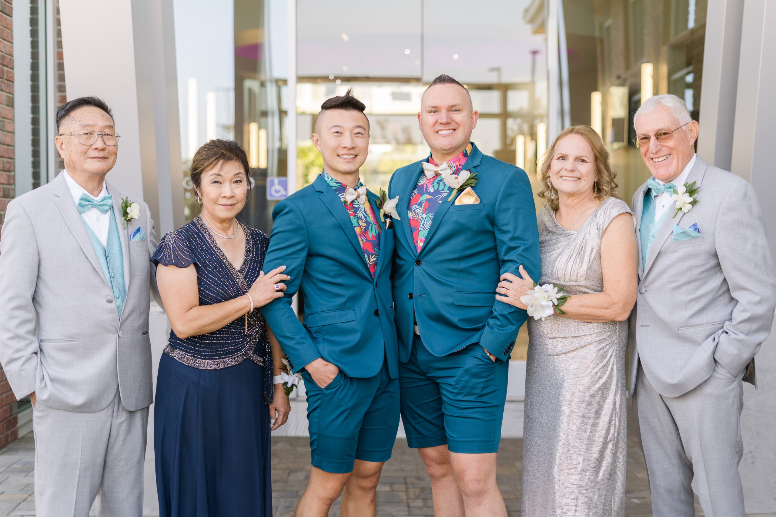 and lgbtq couple poses with their parents for a formal wedding family portrait by adrienne and dani photography, Napa Wedding Photographers