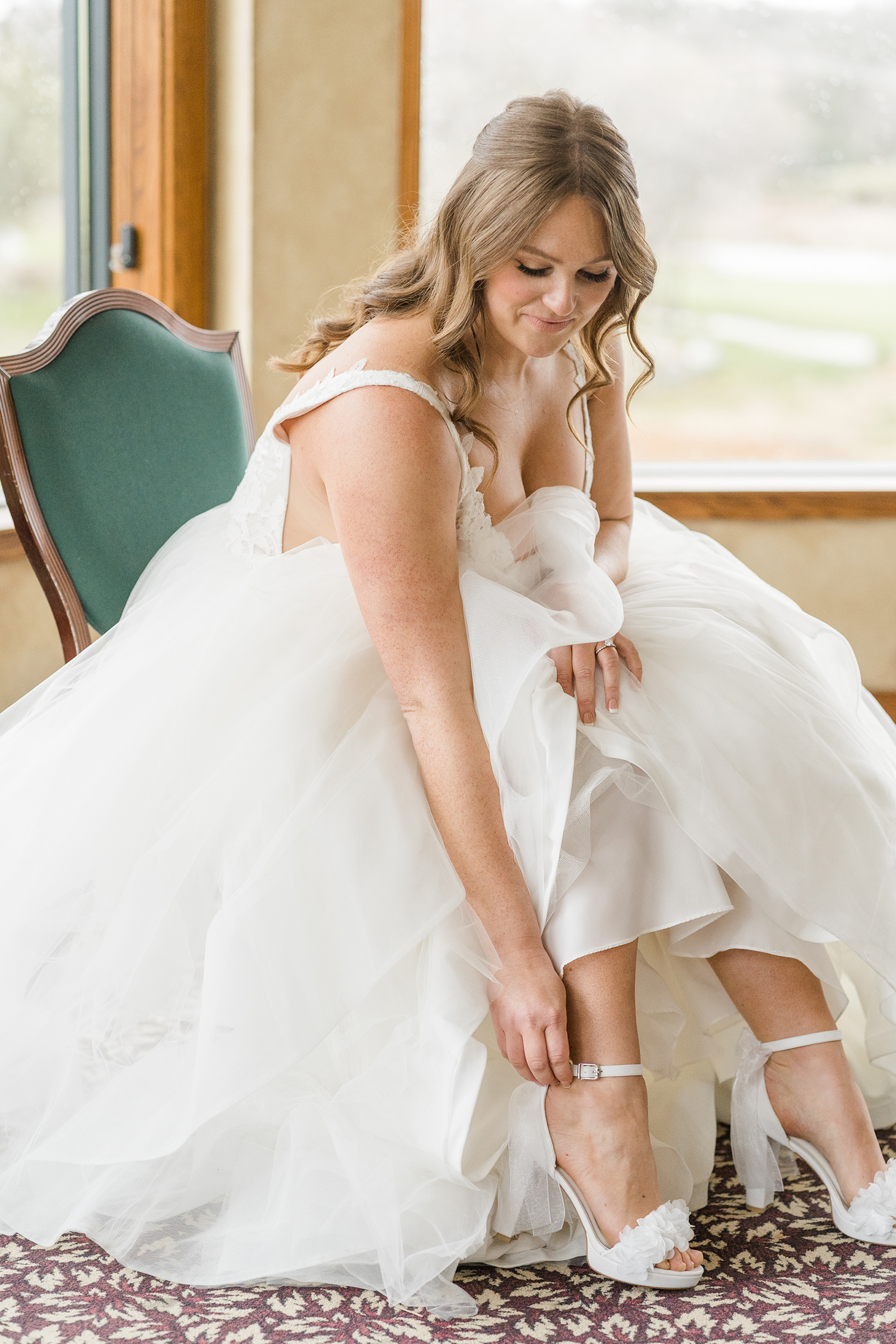 a bride preparing for her wedding at the Ridge Event Center by Adrienne and Dani Photography