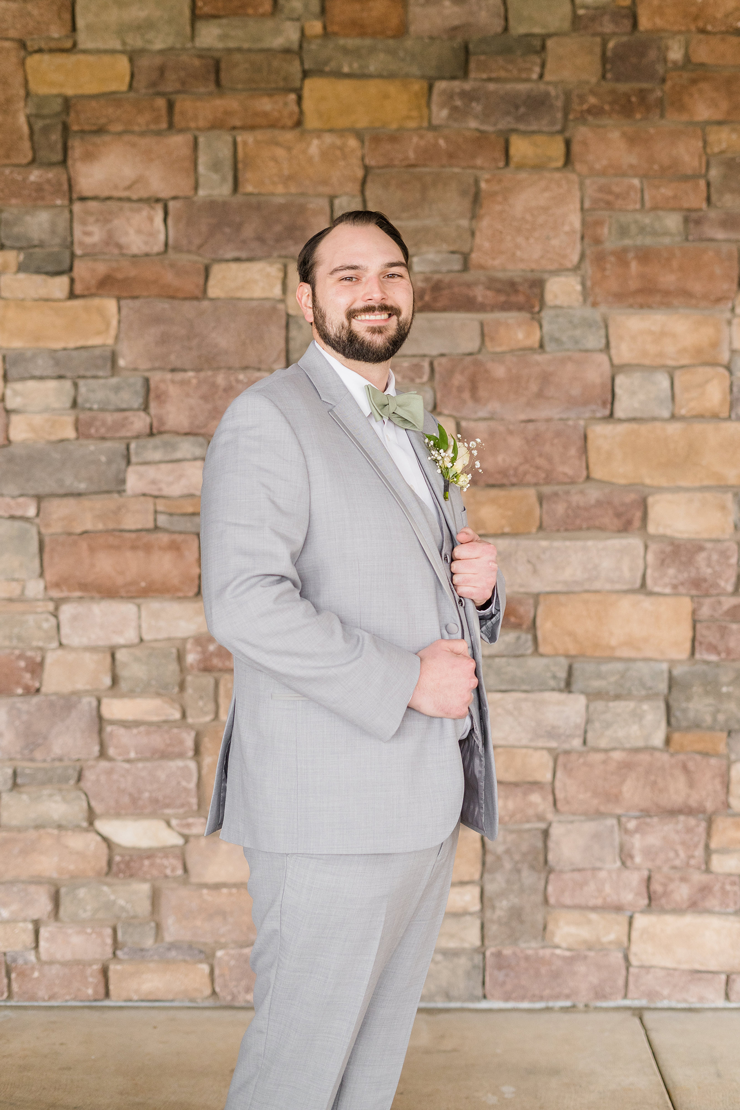 a grooms preparing for his wedding at the Ridge Event Center by Adrienne and Dani Photography