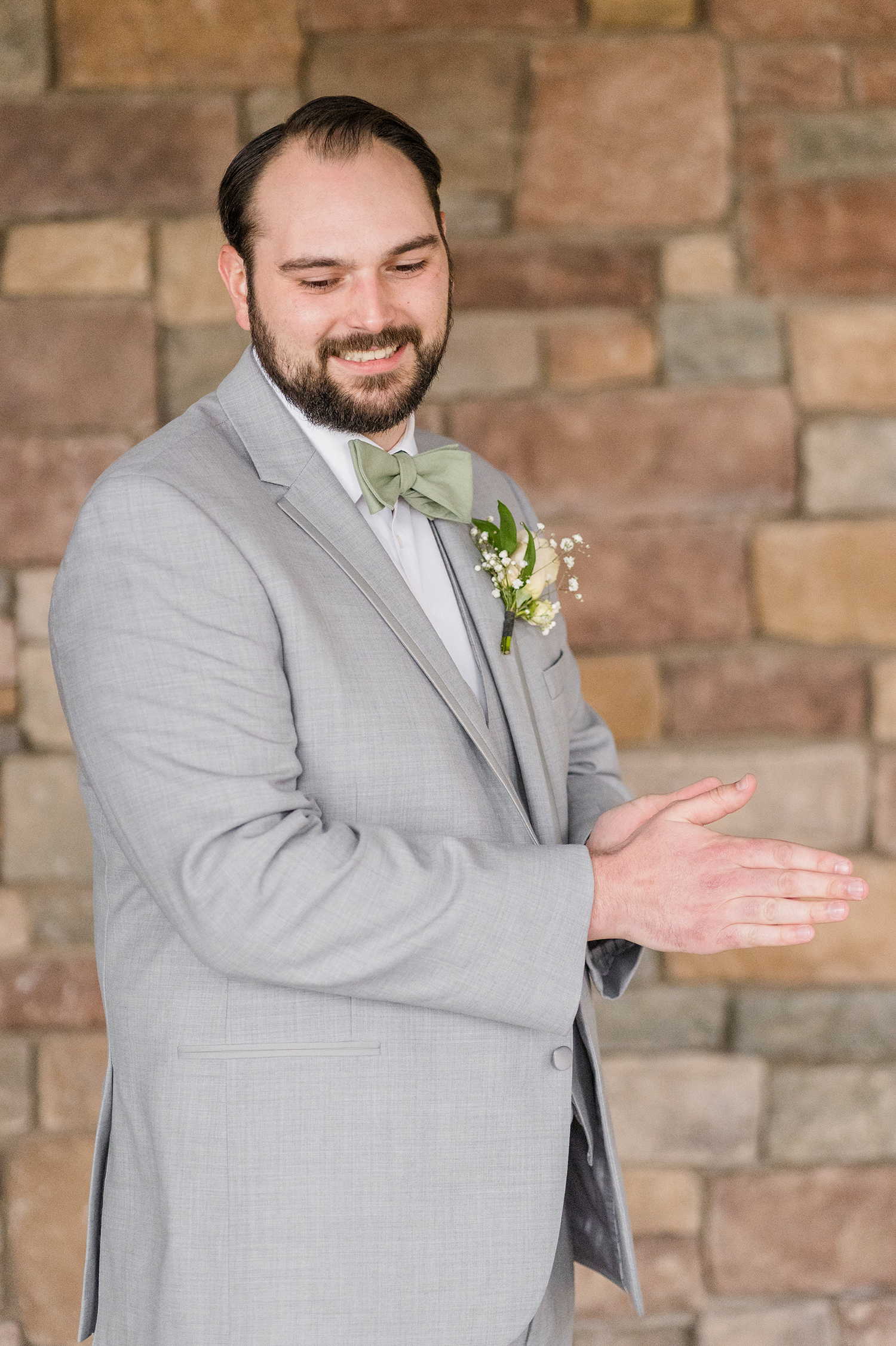 a groom preparing for his wedding at the Ridge Event Center by Adrienne and Dani Photography