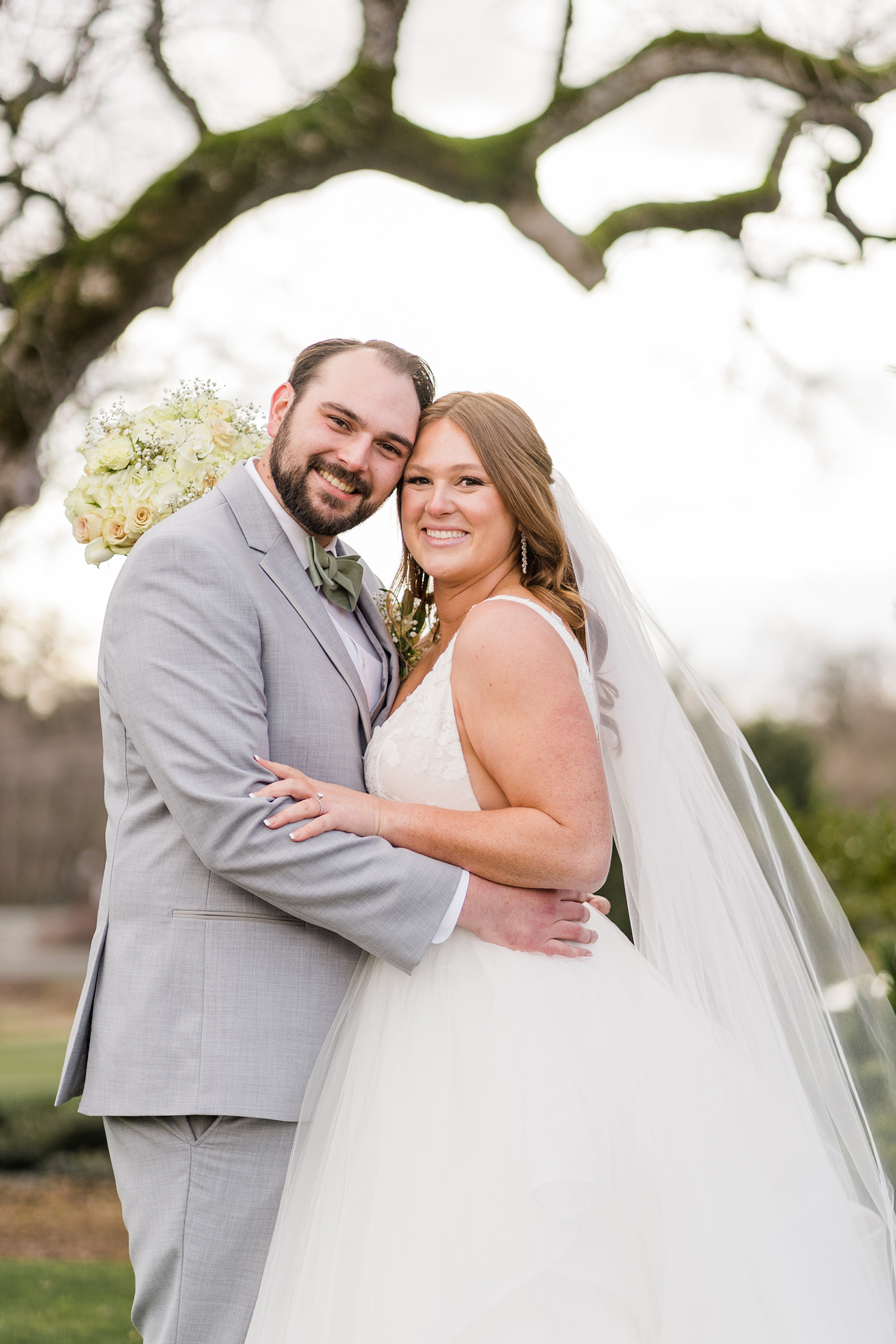 a bride and groom pose for their formal portraits at the Ridge Event Center by Adrienne and Dani Photography