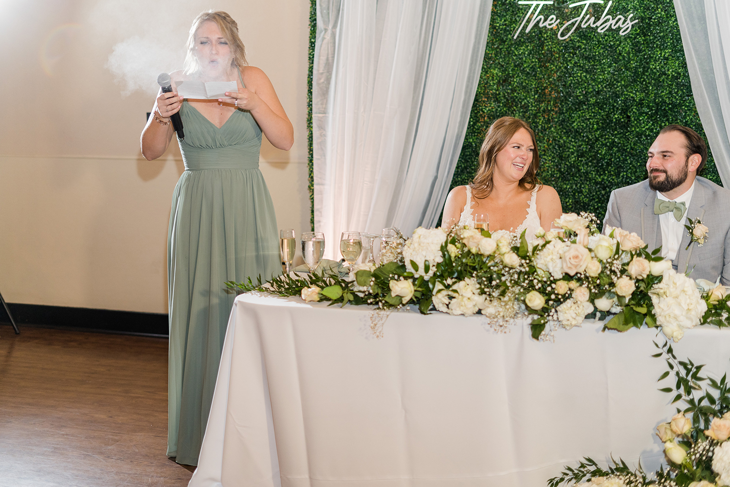 a matron of honor gives a humorous toast at the Ridge Event Center by Adrienne and Dani Photography