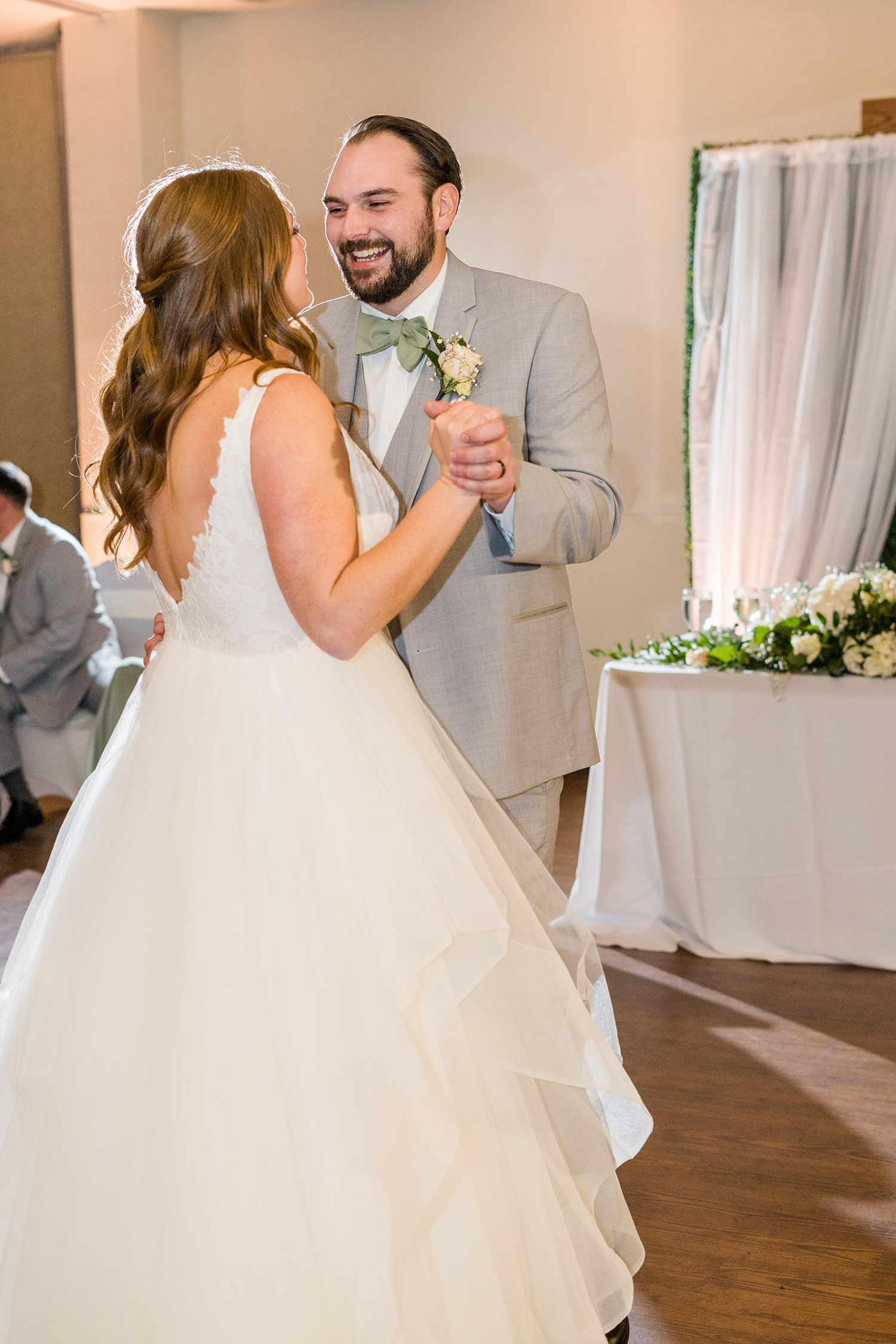 a bride and groom share their first dance at the Ridge Event Center by Adrienne and Dani Photography