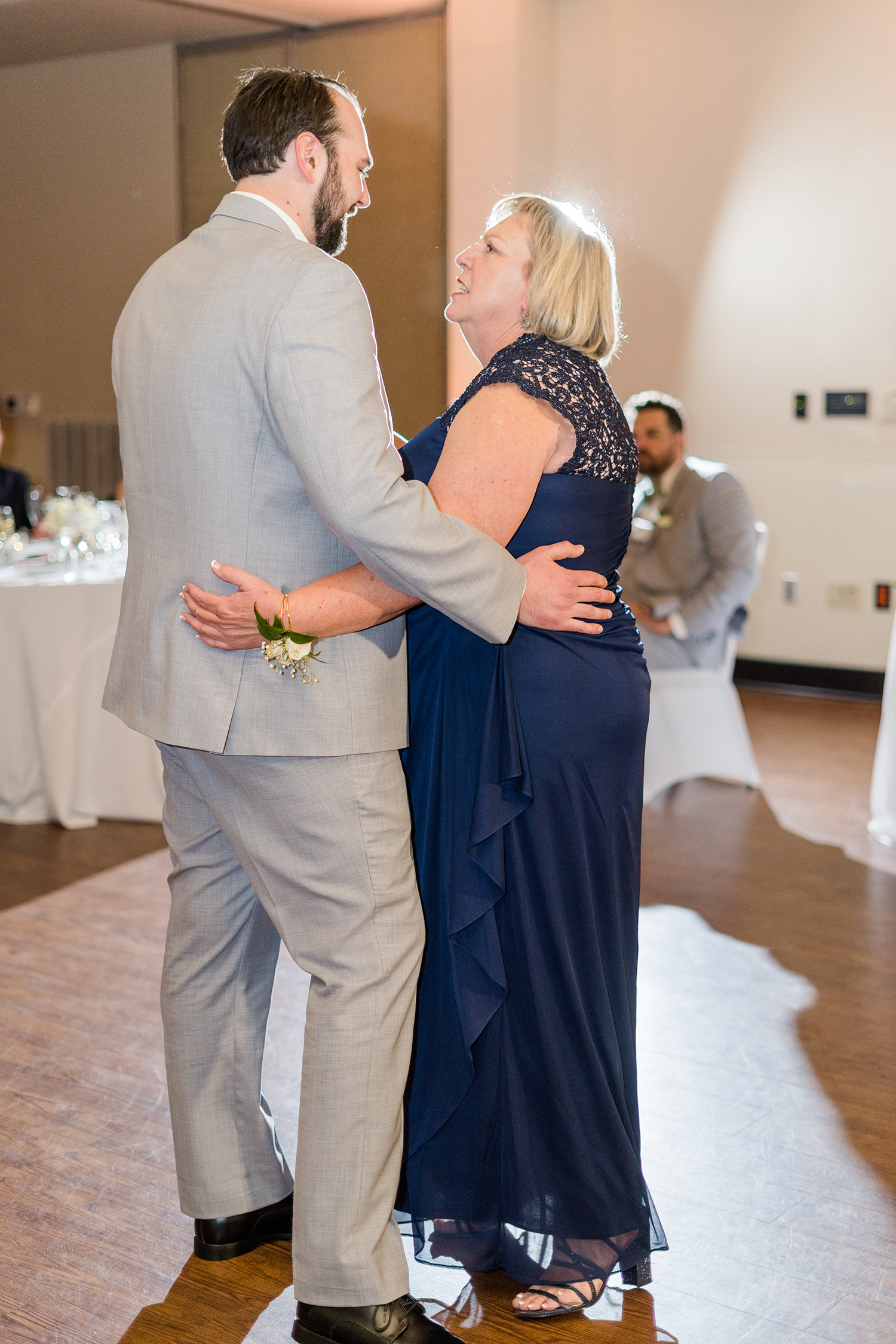 a groom dances with his mother at the Ridge Event Center by Adrienne and Dani Photography