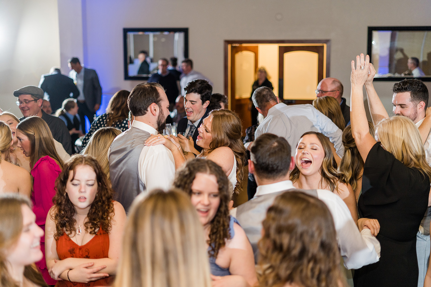 a bride and groom dance together surrounded by their guests at the Ridge Event Center by Adrienne and Dani Photography