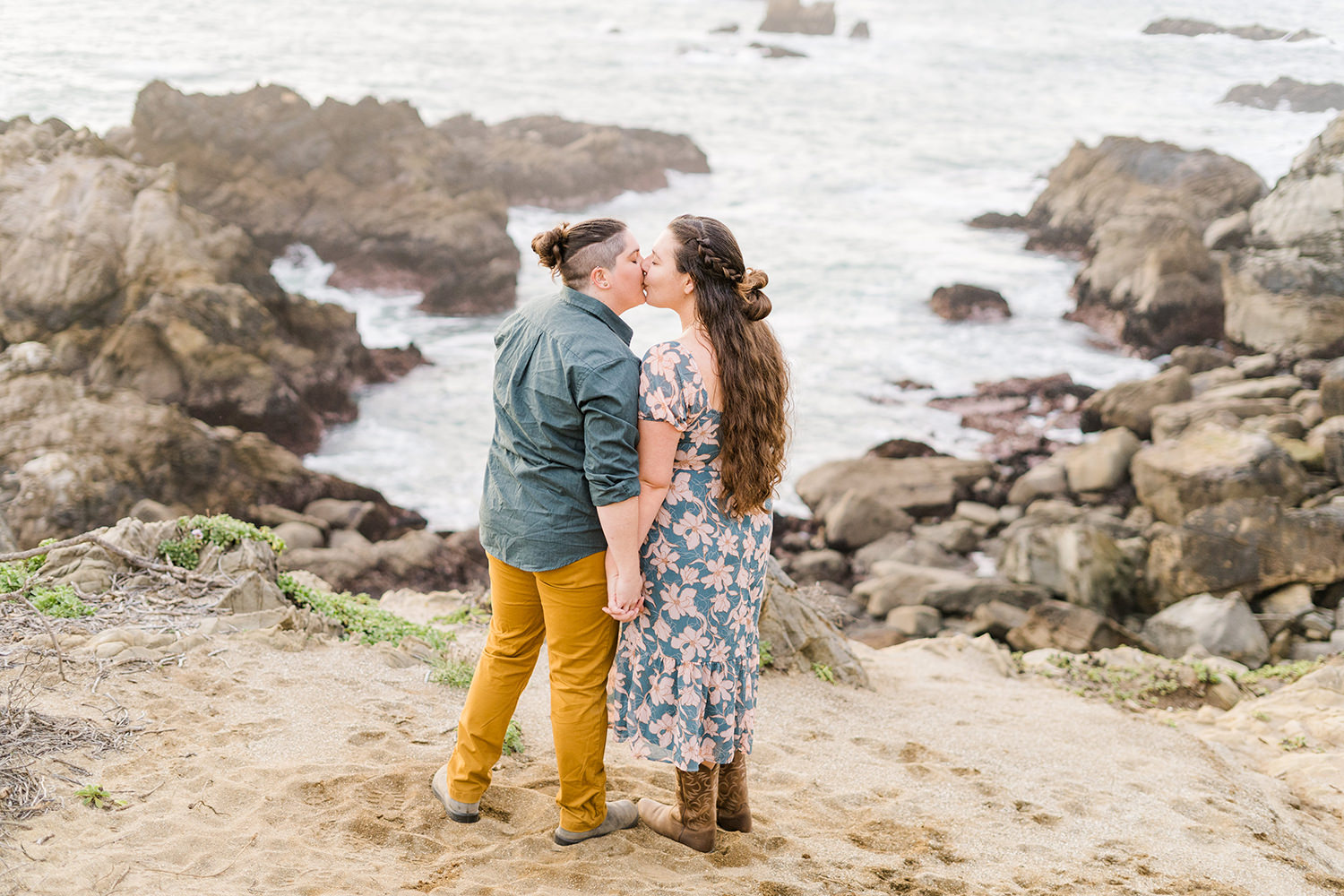 LGBTQIA+ couple shares an intimate moment at their salt point beach engagement session