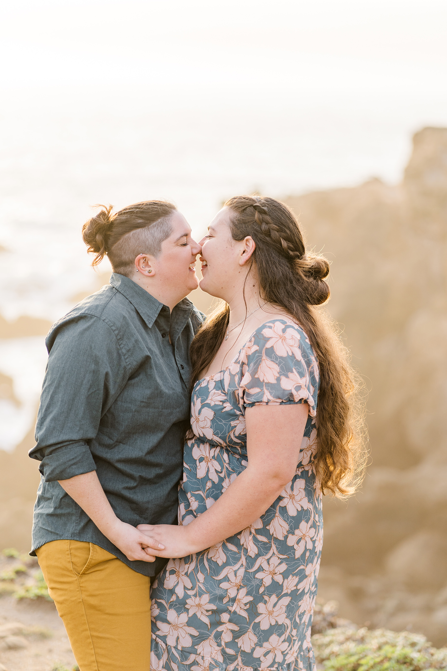 LGBTQIA+ couple shares an intimate moment at their salt point beach engagement session