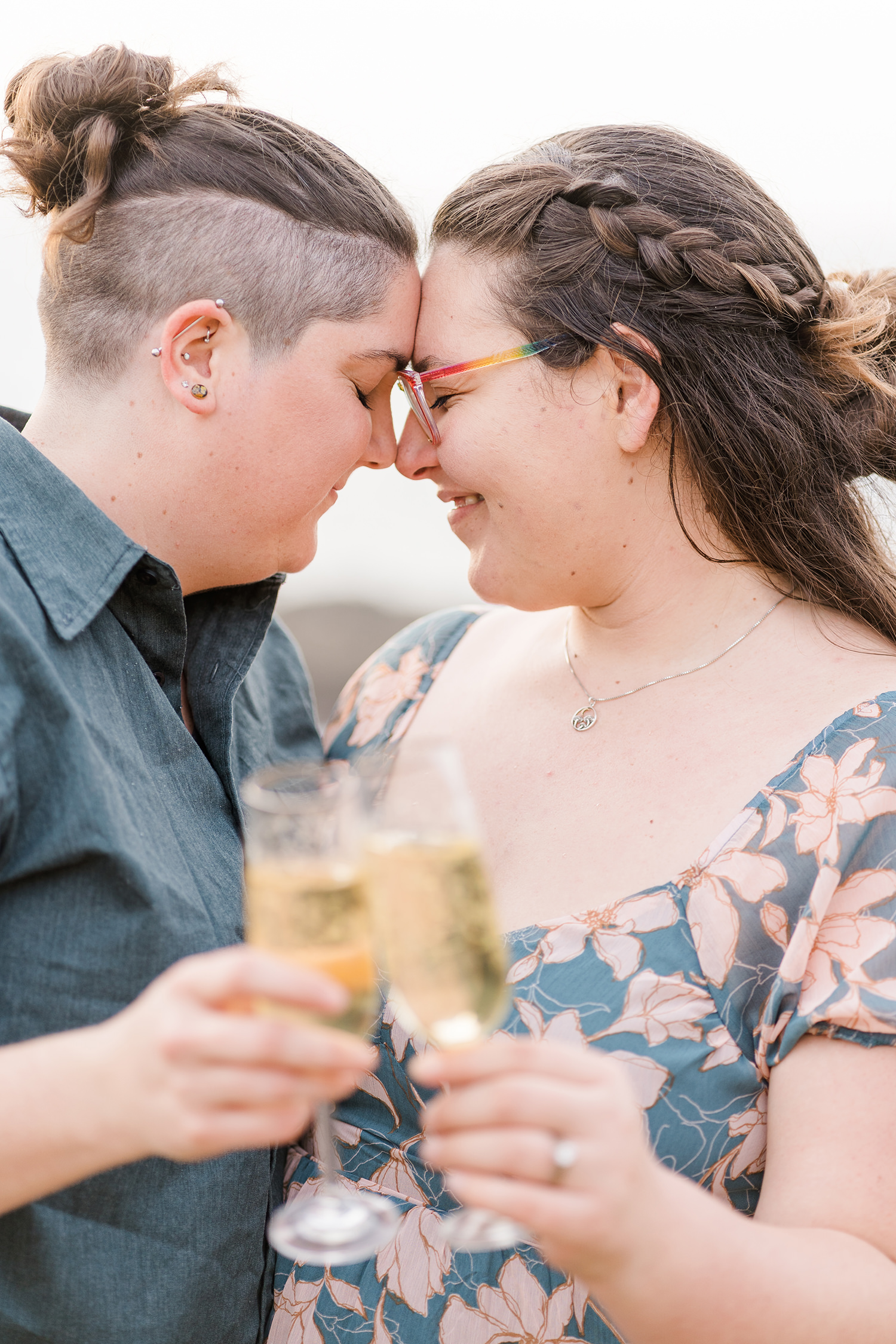 LGBTQIA+ couple shares an intimate moment at their beach engagement session