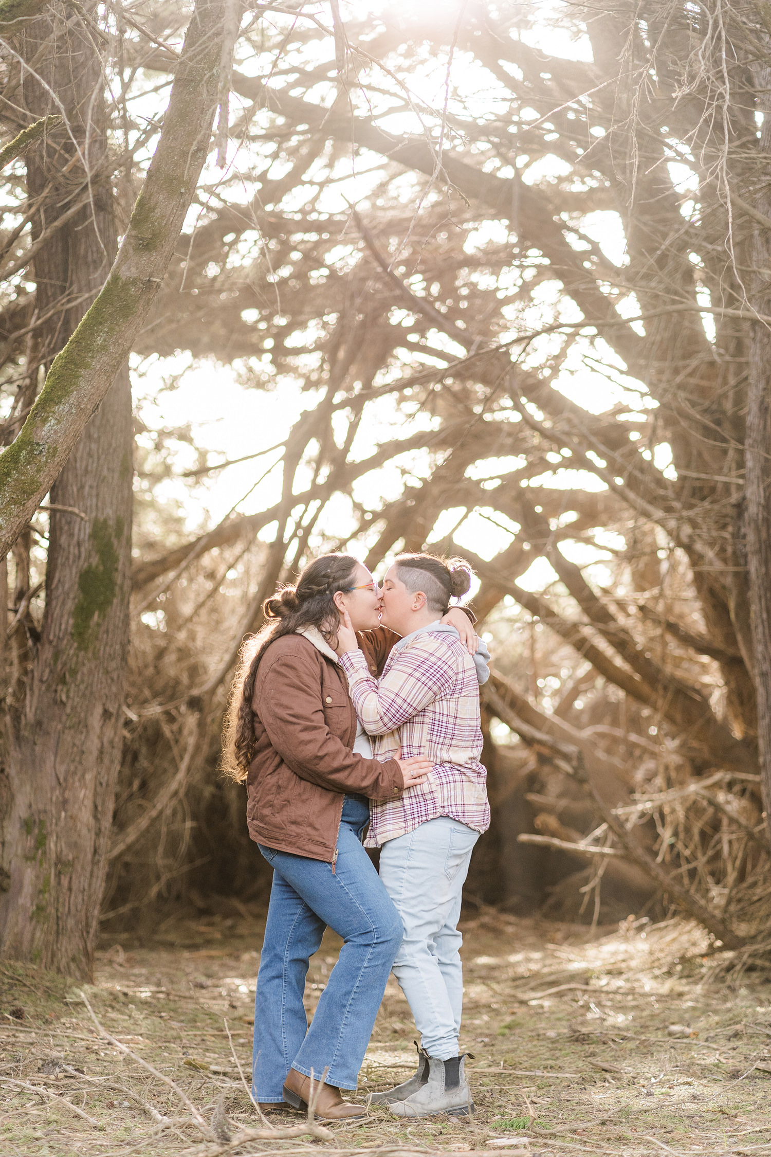 LGBTQIA+ couple shares an intimate moment at their beach engagement session