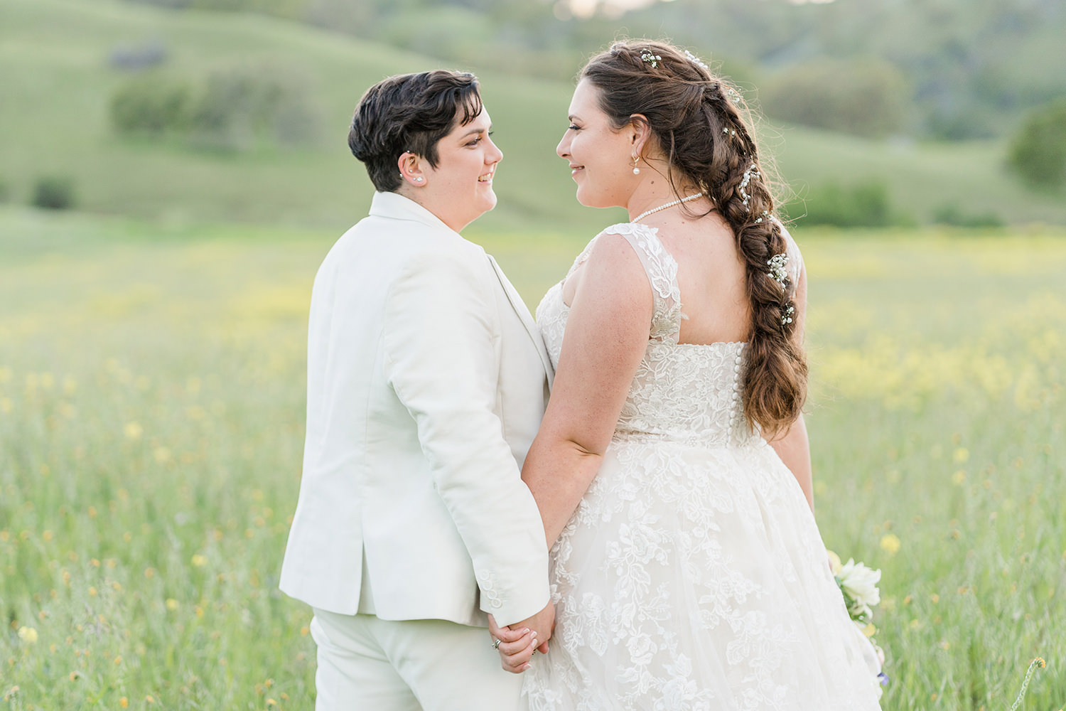 a duo of brides celebrates their wedding at an lgbtq private estate capay wedding by Adrienne and Dani Photography