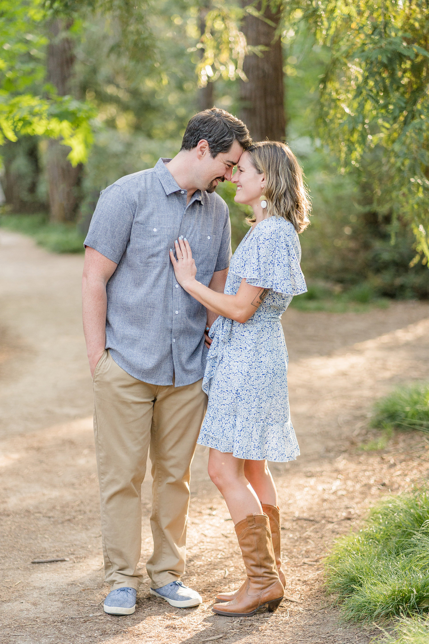 an engaged couple embrace during their redwood grove engagement session