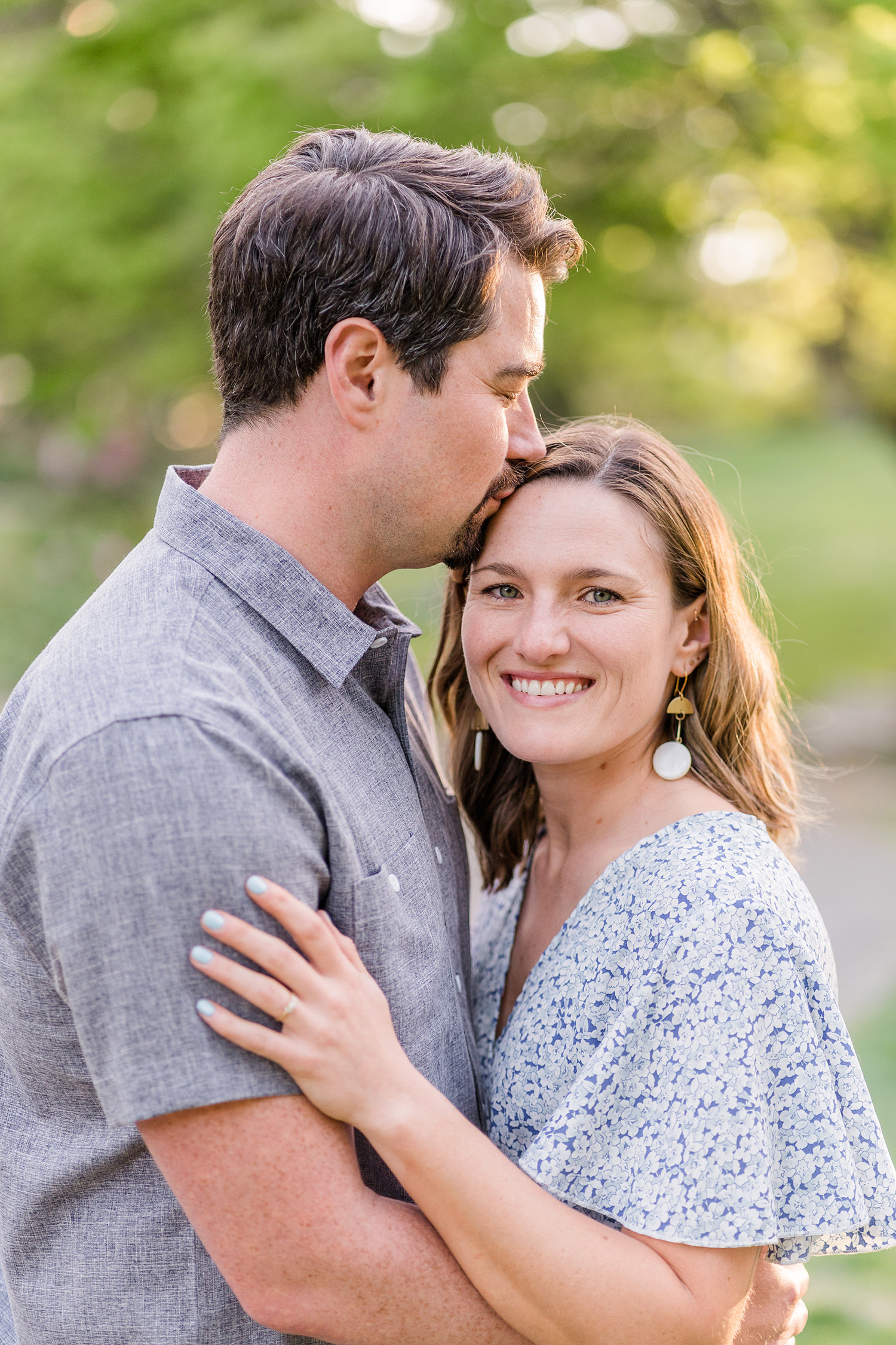 an engaged couple embrace during their redwood grove engagement session