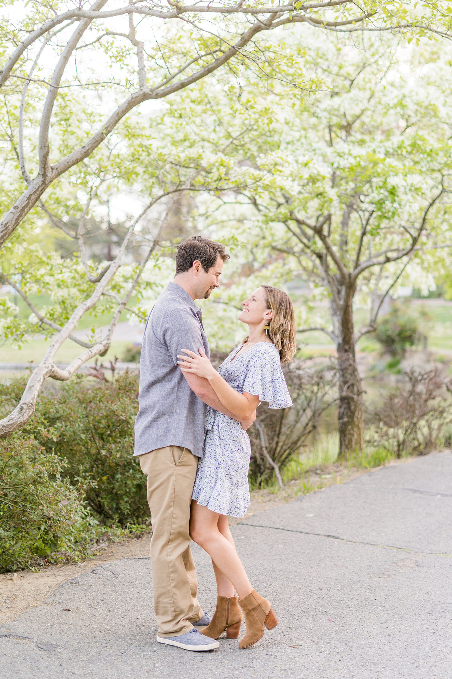 an engaged couple embrace during their uc davis arboretum engagement session in the redwood grove