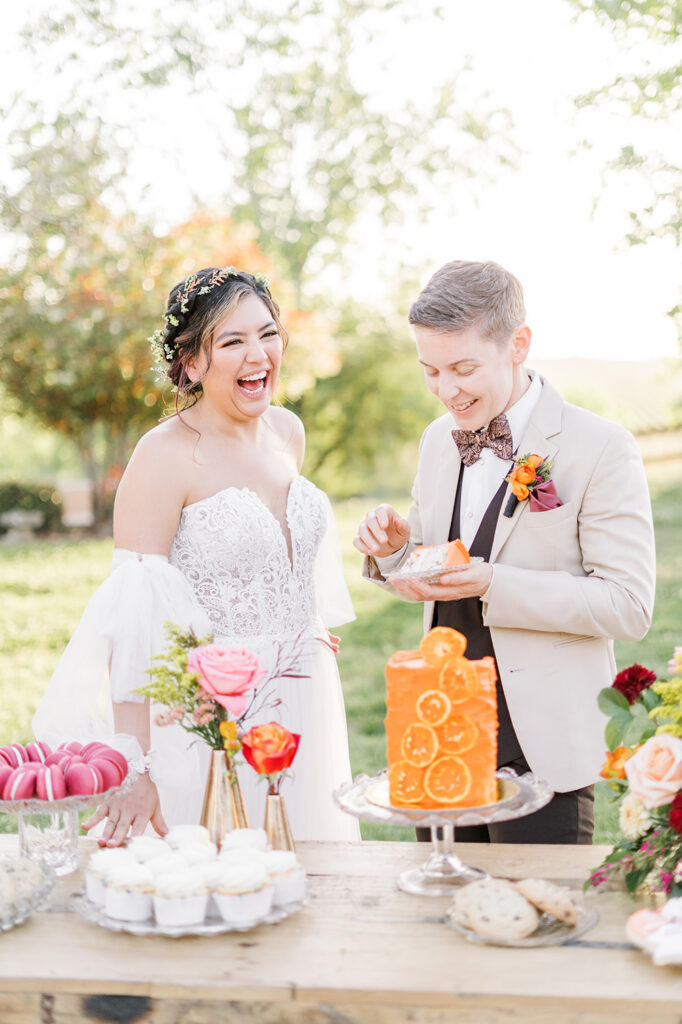 an lgbtq couple cuts their wedding cake at hanford ranch winery in galt, ca