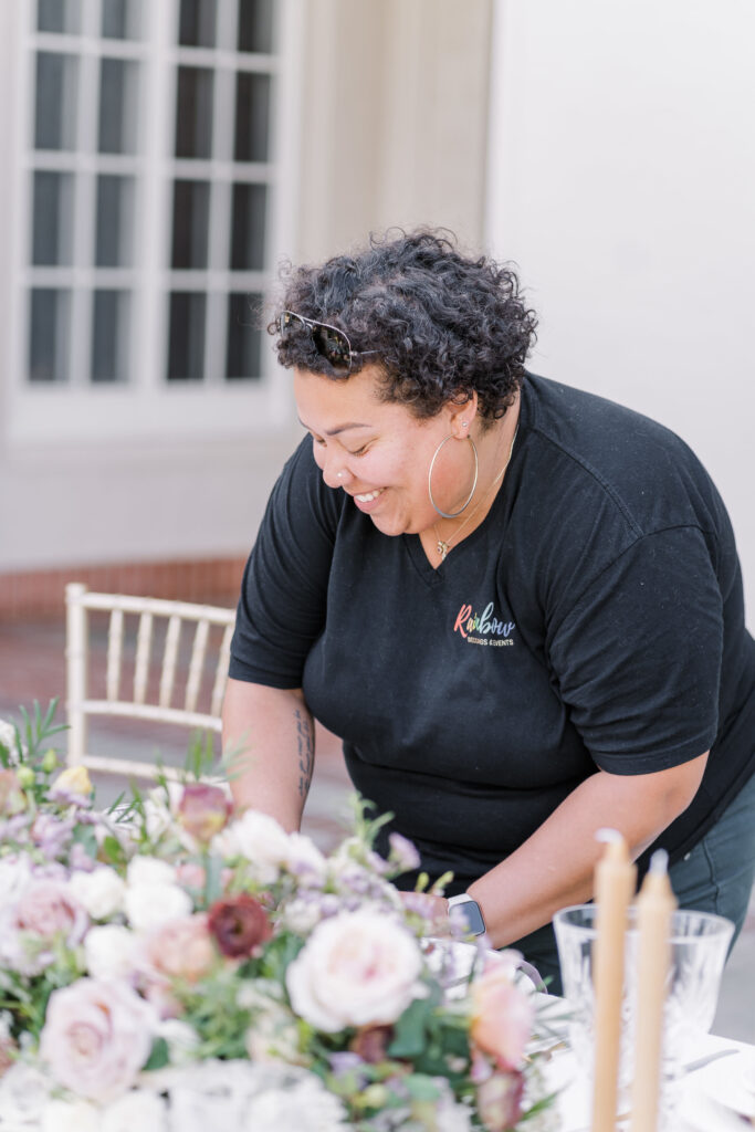 LGBT Business Rainbow Weddings and Events sets up a table setting for a villa montalvo wedding 