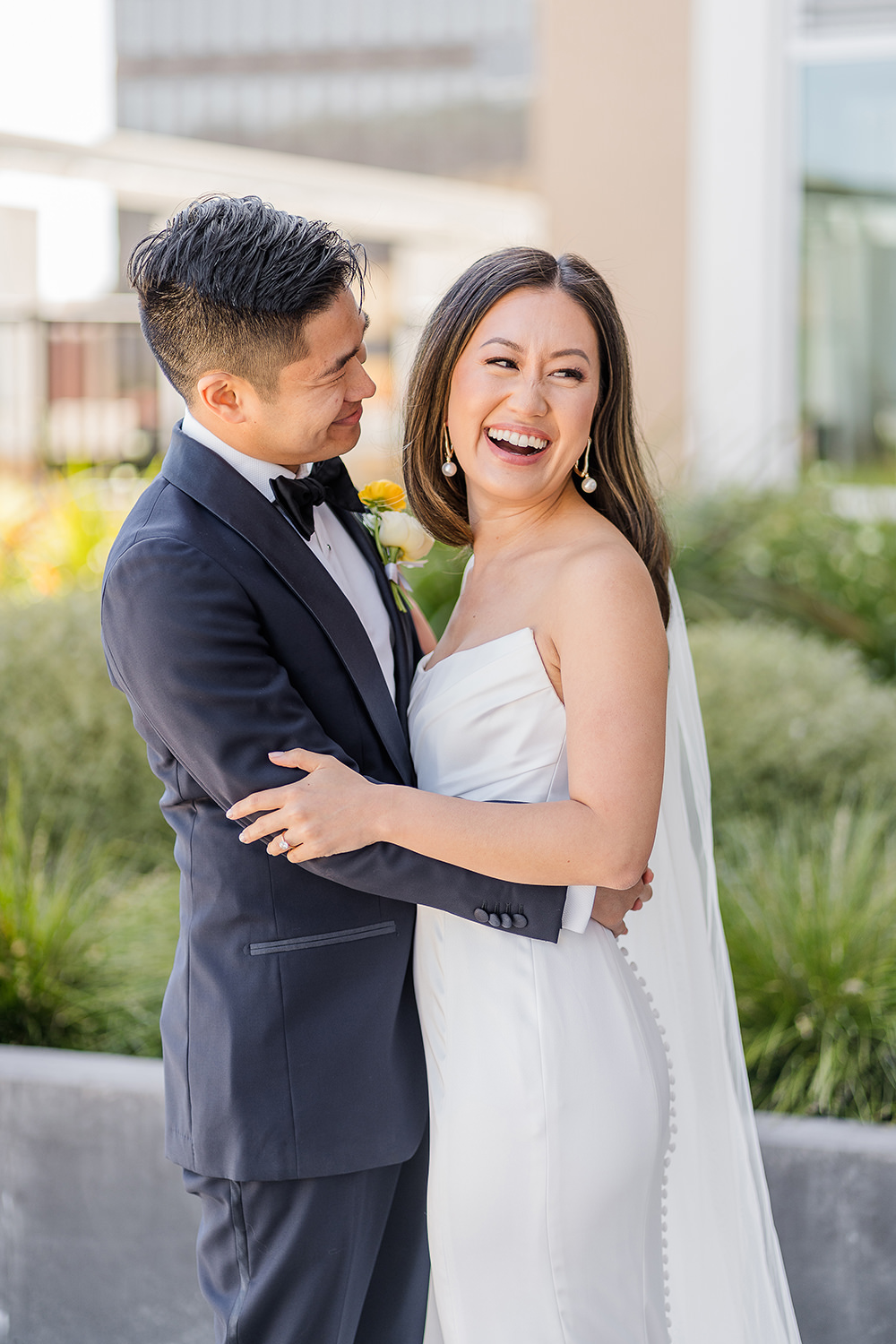 a bride and groom laugh together at their Piedmont Park Wedding