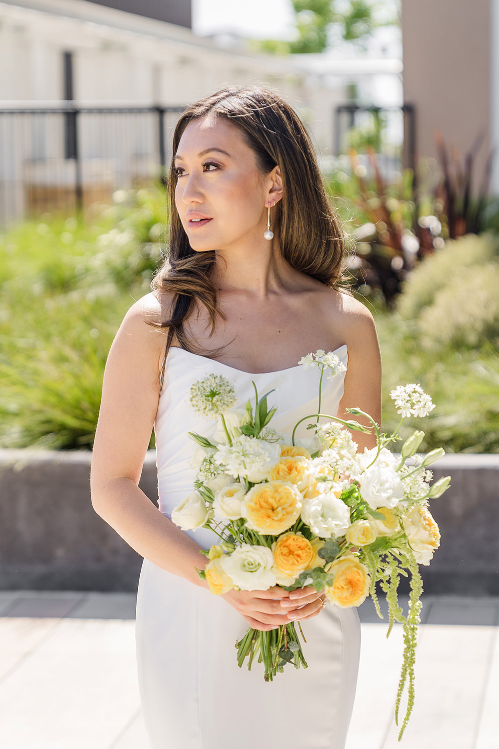 a bride poses holding her bouquet for a portrait at her Piedmont Park Wedding