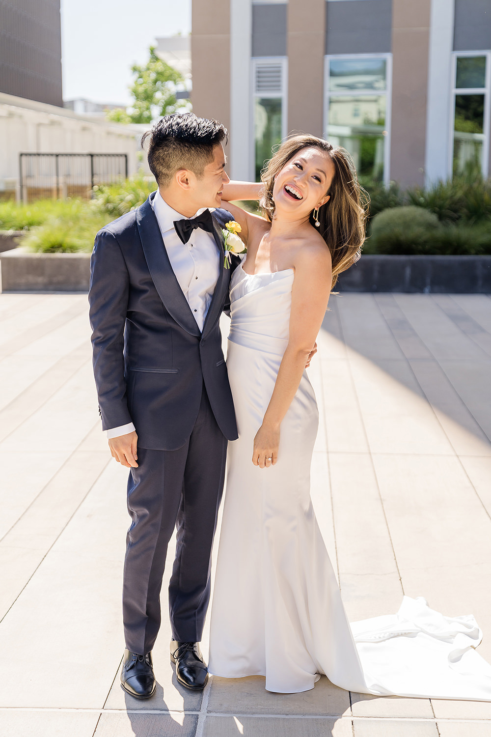 a bride and groom share a laugh together at their Piedmont Park Wedding