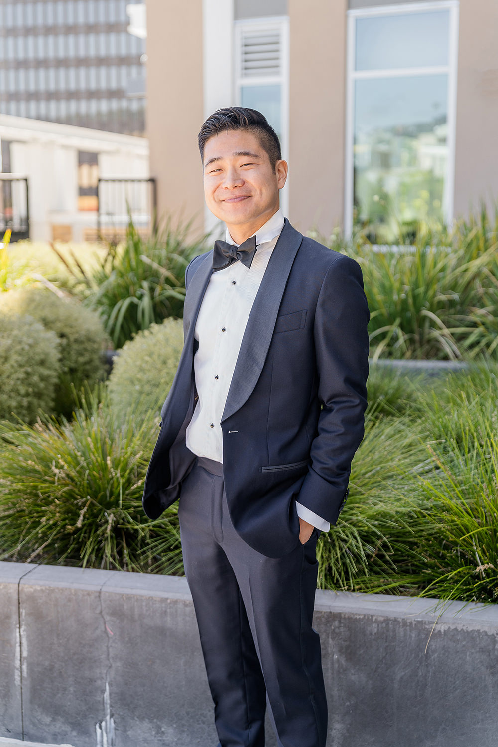 a groom poses for a portrait at his Piedmont Park Wedding