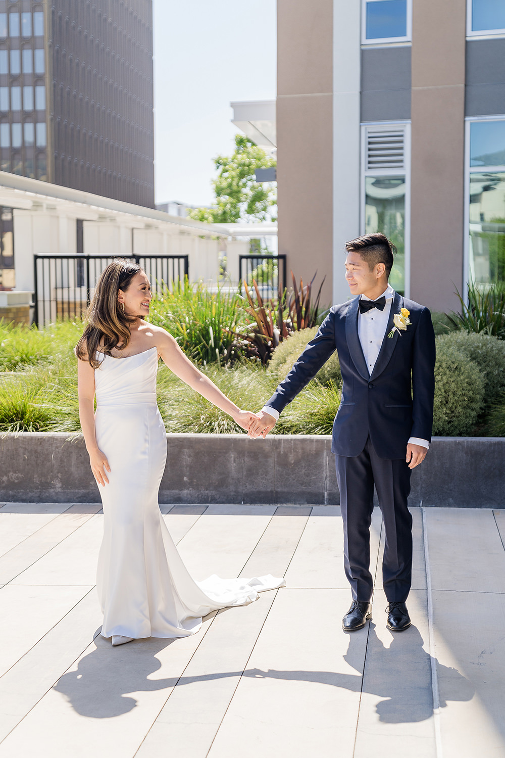 a bride and groom hold hands at their Piedmont Park Wedding