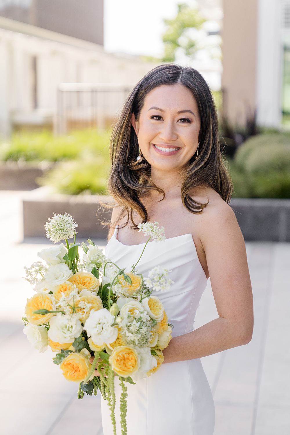 a bride poses with her bouquet for a portrait at her Piedmont Park Wedding