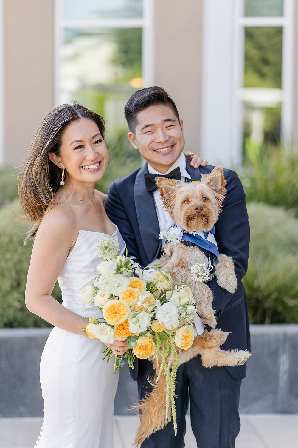 a bride and groom pose with their dog at their Piedmont Park Wedding