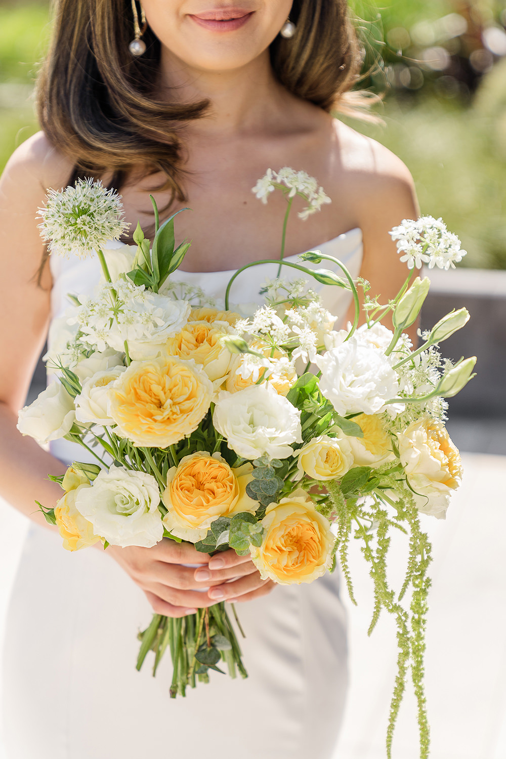 a bride poses with her bouquet for a portrait at her Piedmont Park Wedding