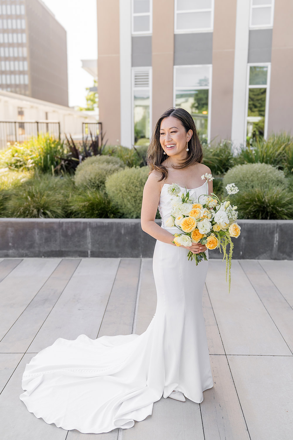 a bride poses with her bouquet for a portrait at her Piedmont Park Wedding