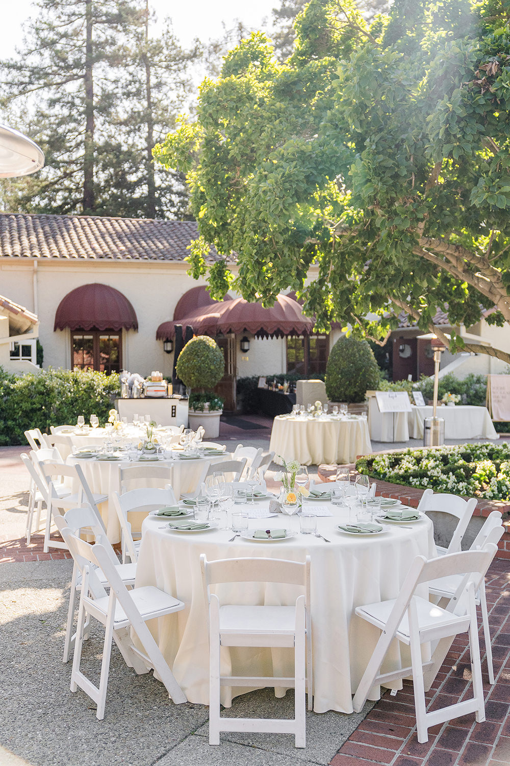 a reception table set up with white and sage green table linens at a Piedmont Park Wedding