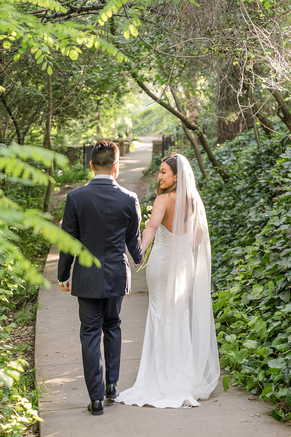 a bride and groom walking down an ivy path from their Piedmont Park Wedding