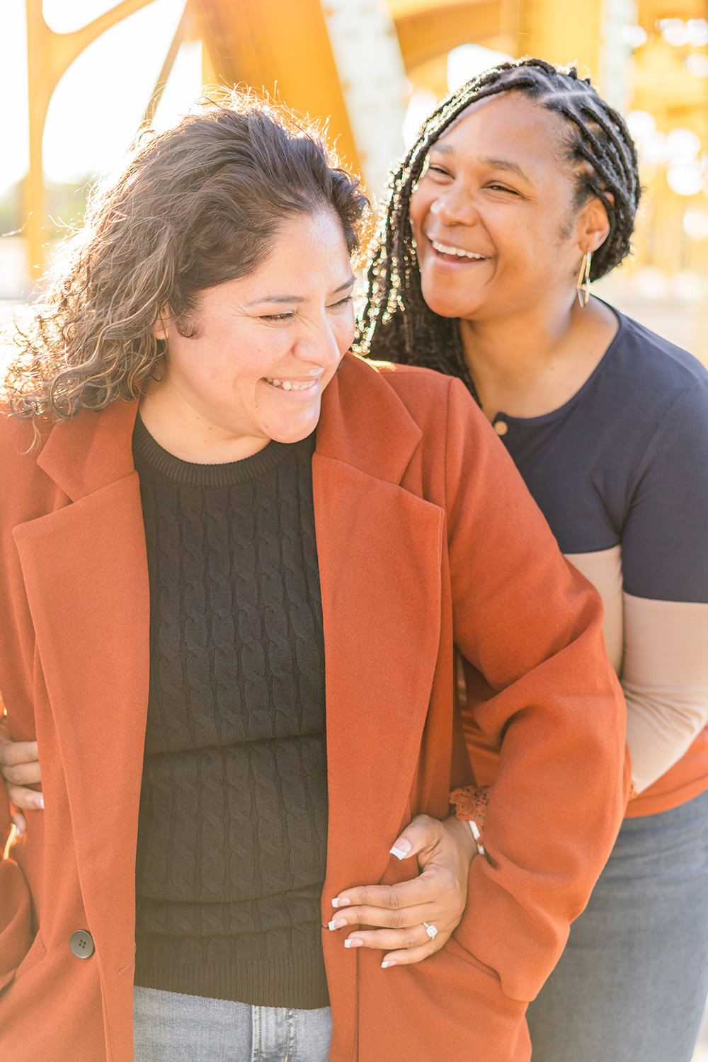 a lgbt lesbian couple share a laugh at their Downtown Sacramento LGBT Engagement Photos