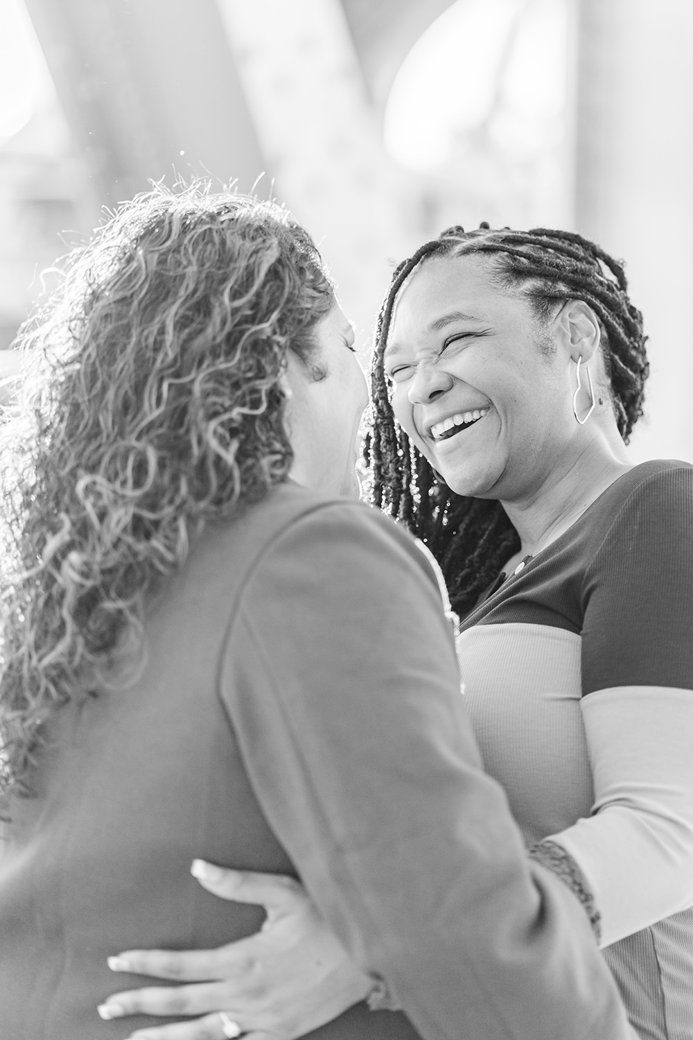 a lgbt lesbian couple share a laugh at their Downtown Sacramento LGBT Engagement Photos