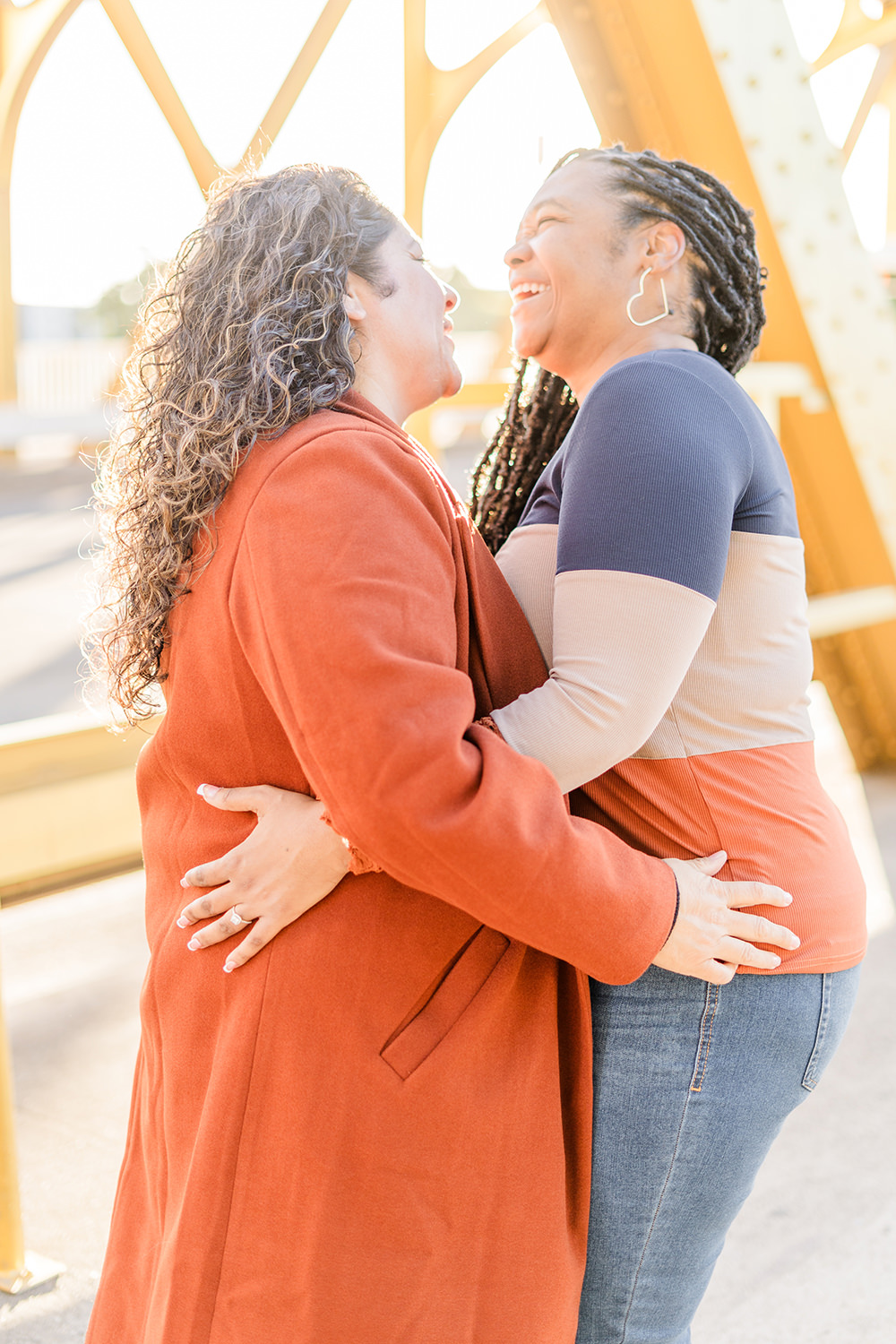 a lgbt lesbian couple share a laugh at their Downtown Sacramento LGBT Engagement Photos