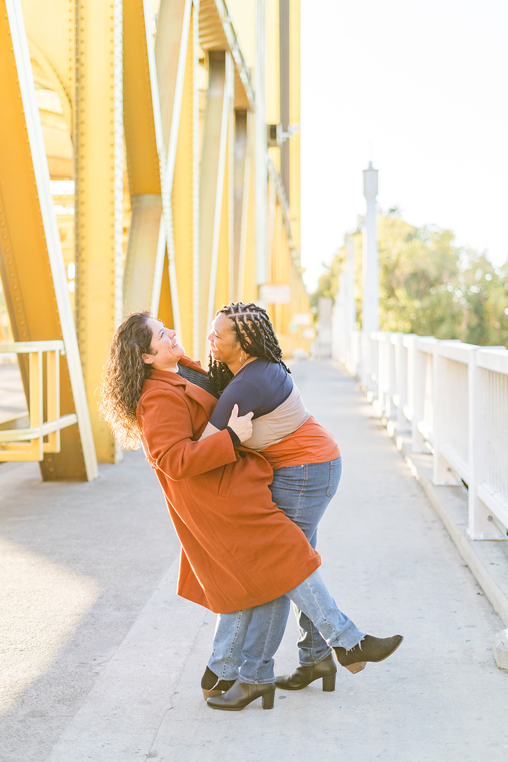 a lgbt lesbian couple share a laugh at their Downtown Sacramento LGBT Engagement Photos