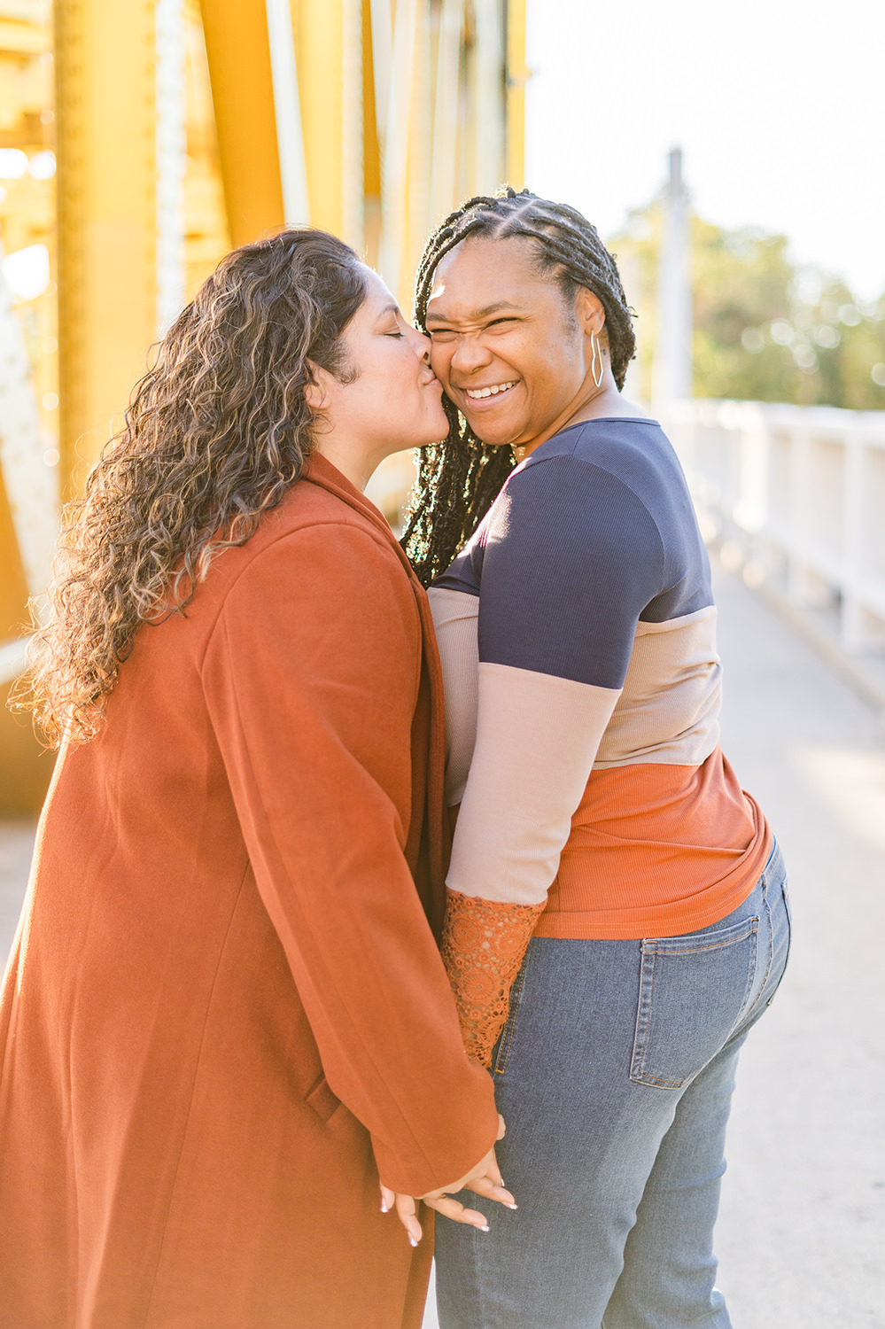 a lgbt lesbian couple share a laugh at their Downtown Sacramento LGBT Engagement Photos