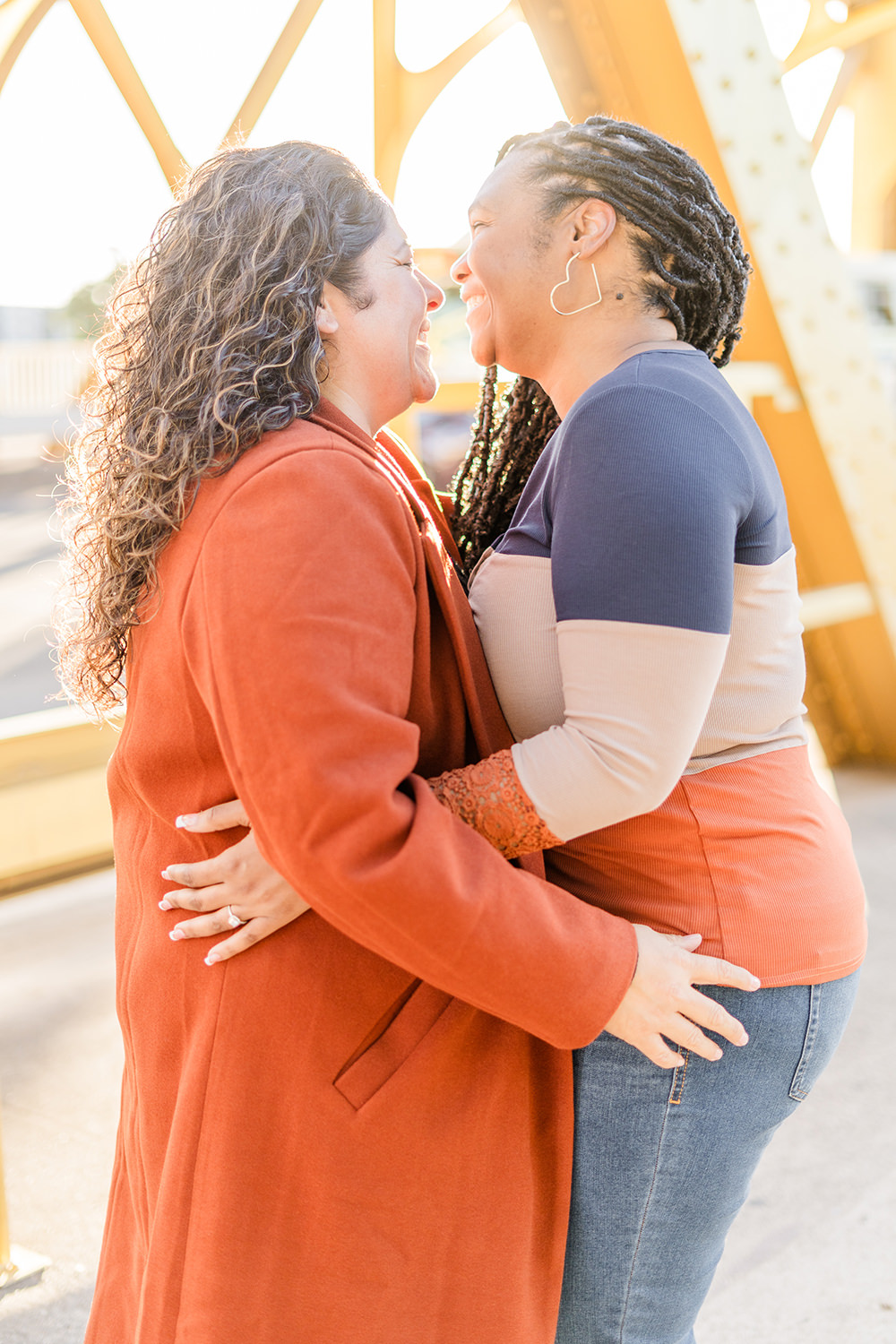 a lgbt lesbian couple share a laugh at their Downtown Sacramento LGBT Engagement Photos