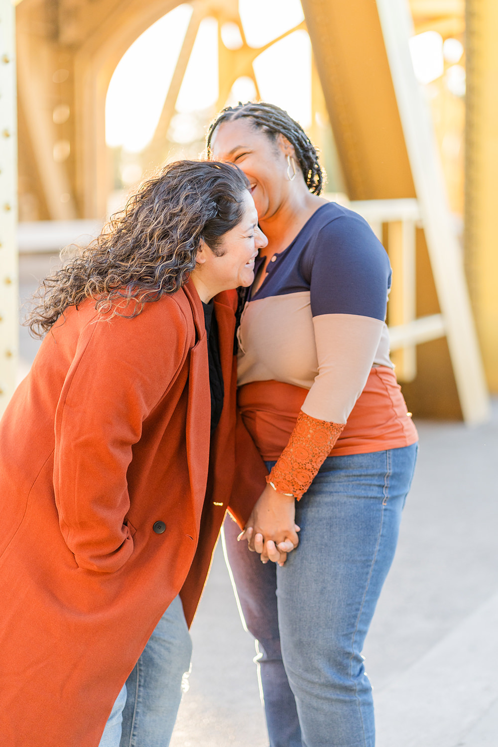 a lgbt lesbian couple share a laugh at their Downtown Sacramento LGBT Engagement Photos