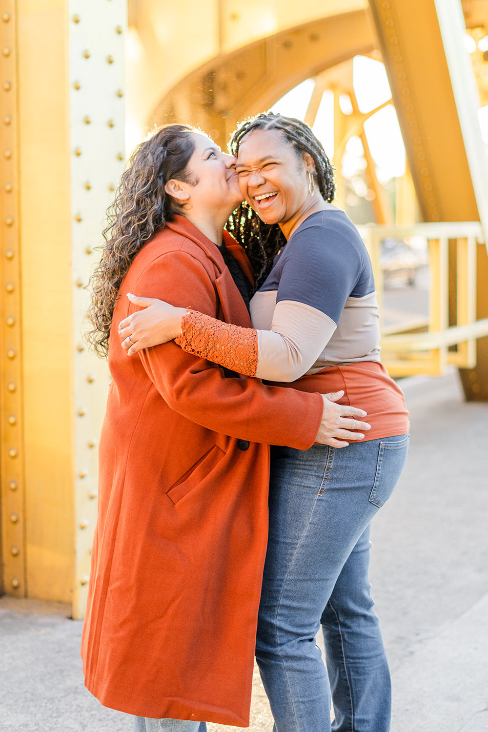 a lgbt lesbian couple share a laugh at their Downtown Sacramento LGBT Engagement Photos