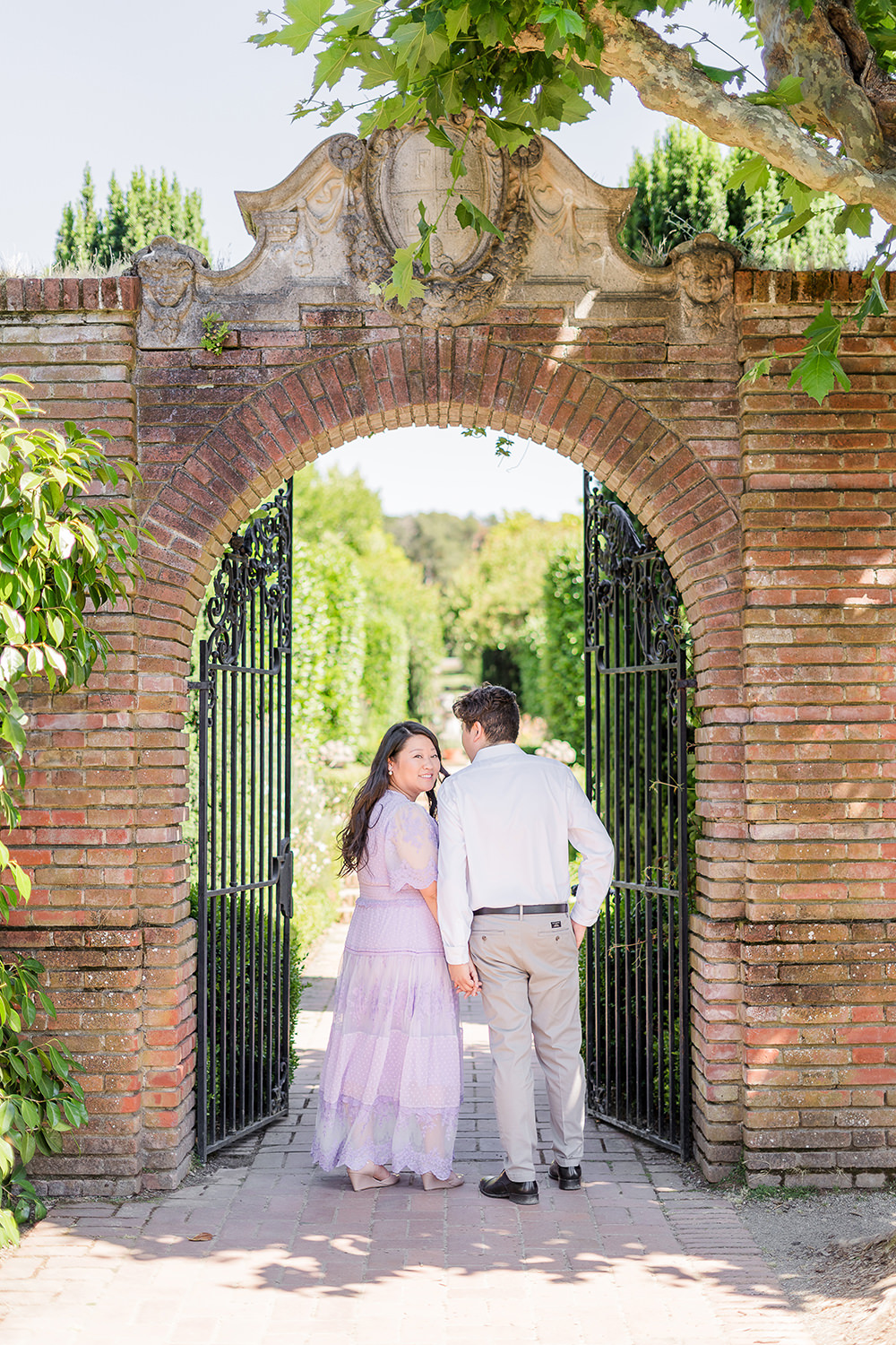 a bride and groom to be share an moment together during their filoli gardens engagement photos.