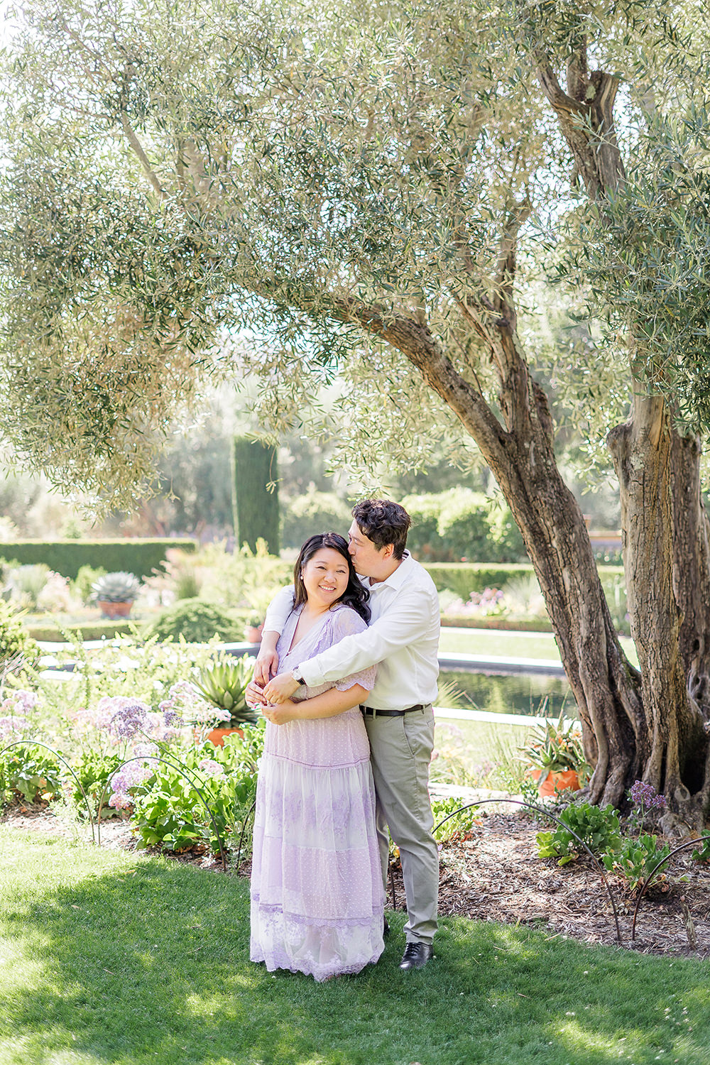 a bride and groom to be share an moment together during their filoli gardens engagement photos.