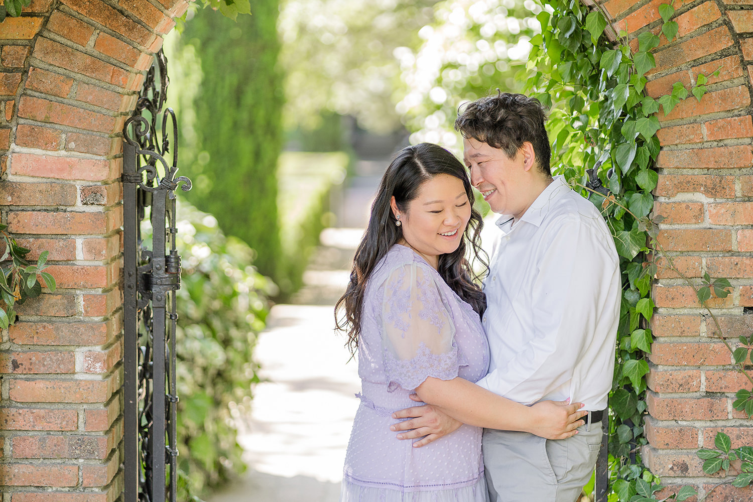 a bride and groom to be share an moment together during their filoli gardens engagement photos.