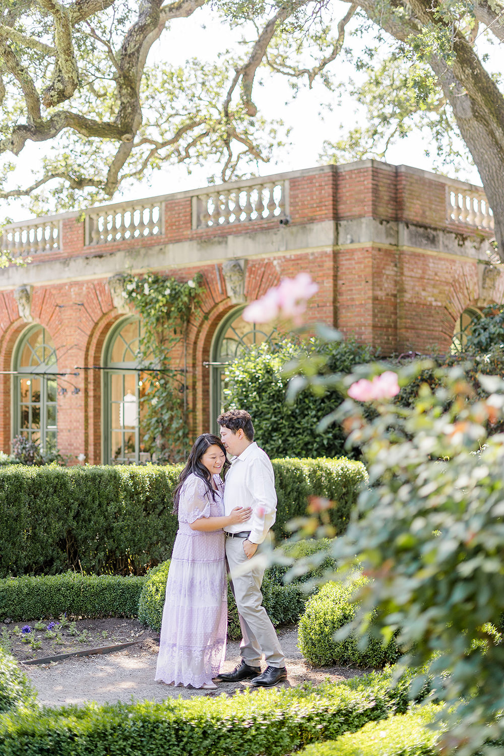 a bride and groom to be share an moment together during their filoli gardens engagement photos.