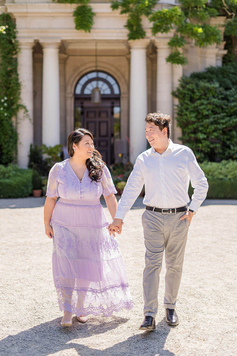 a bride and groom to be walk holding hands during their filoli gardens engagement photos.