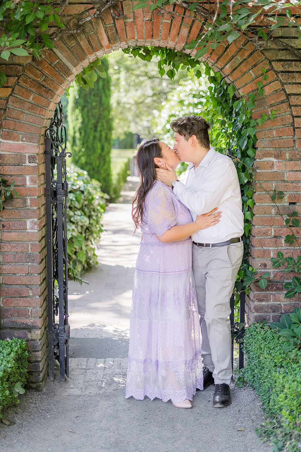 a bride and groom to be share a kiss during their filoli gardens engagement photos.